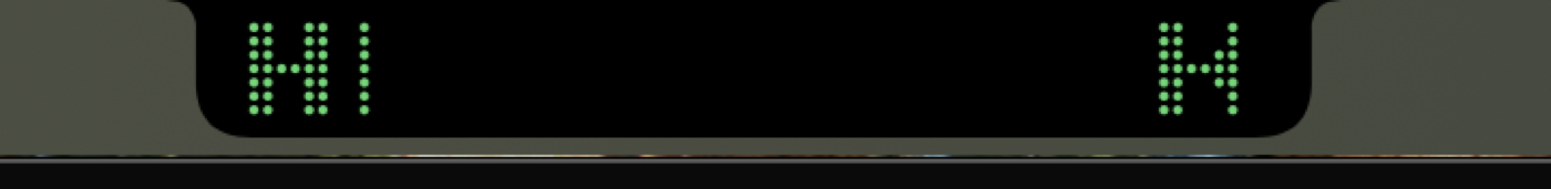 The dot-matrix ticker scrolling around the notch.